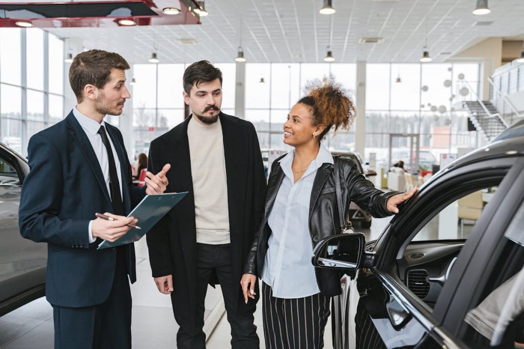 a couple talking to a car dealer