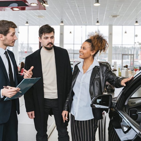 a couple talking to a car dealer